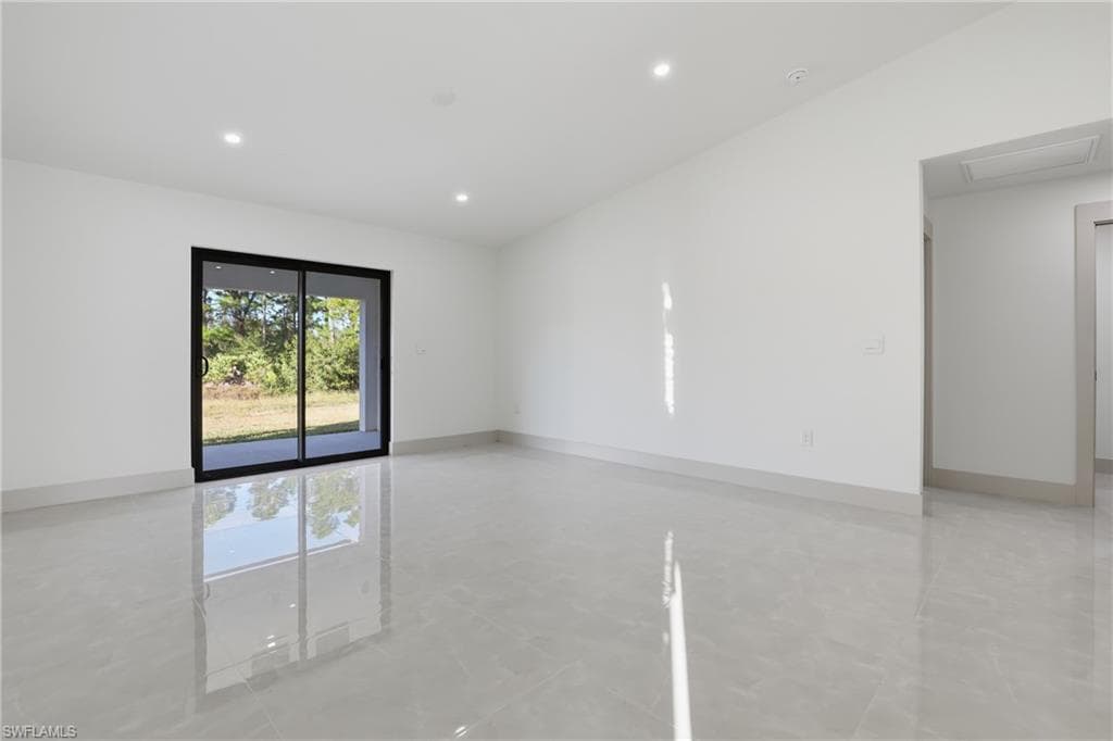 Unfurnished room featuring recessed lighting and baseboards