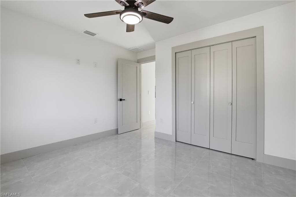 Unfurnished bedroom with a closet and ceiling fan