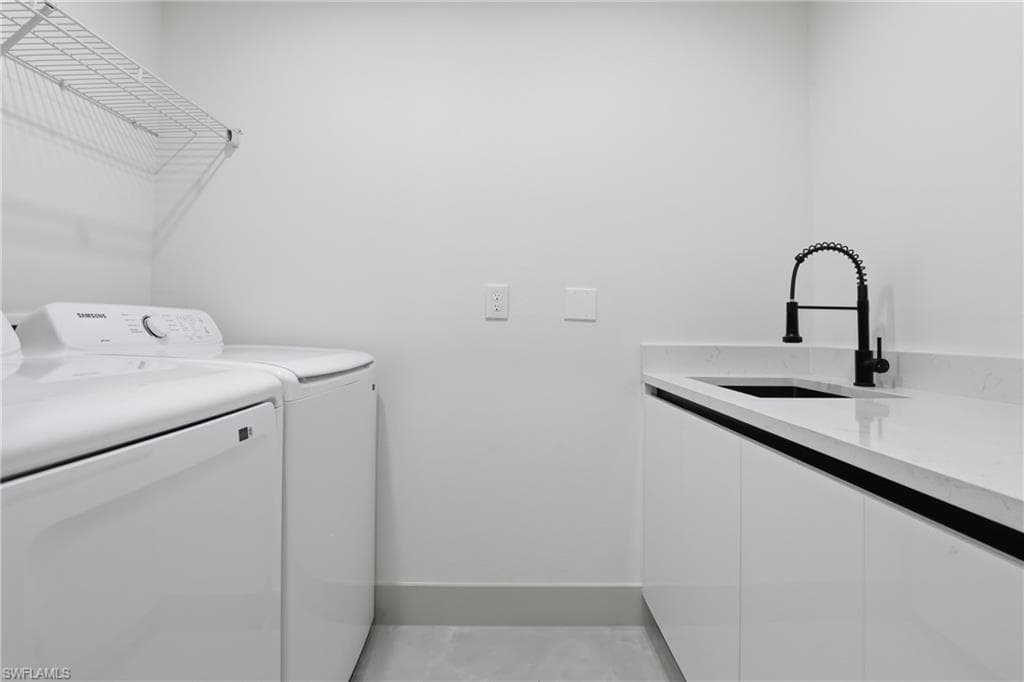 Washroom with washer and dryer and cabinet space