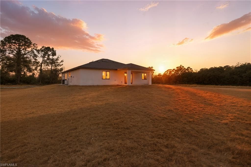 View of front of home featuring a patio and a lawn
