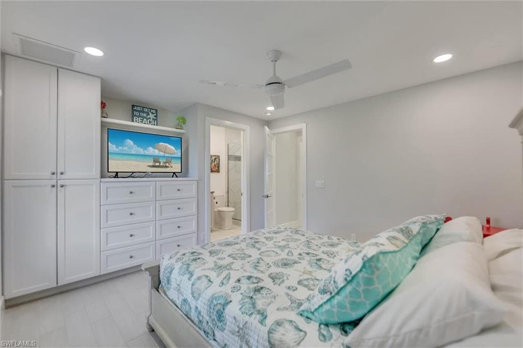 Bedroom featuring recessed lighting, ceiling fan, a closet, ensuite bath, and attic access