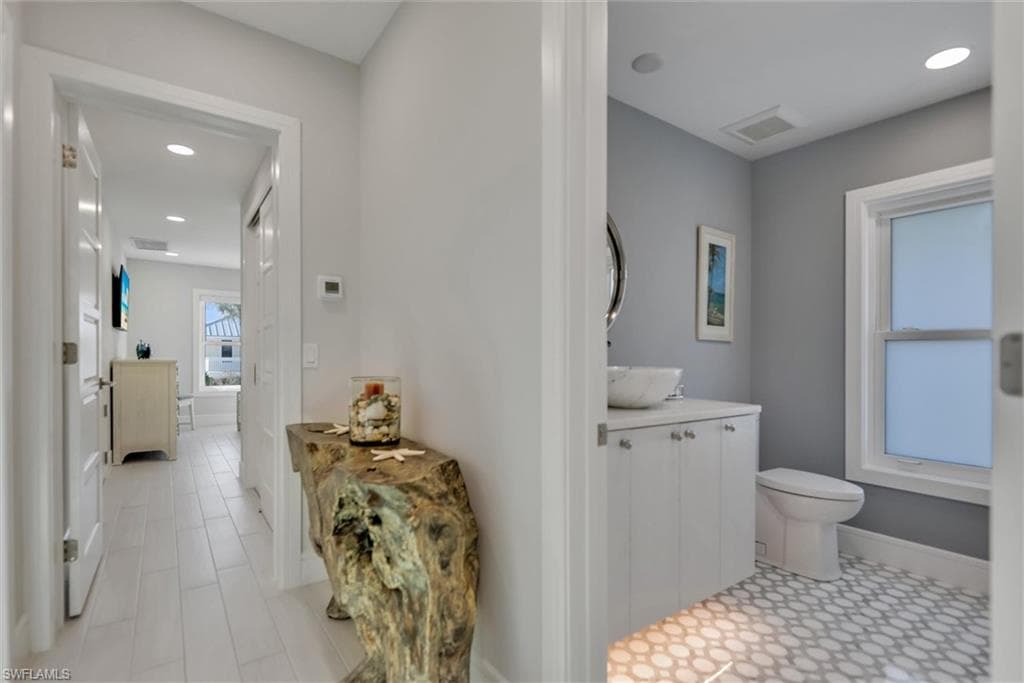Half bath featuring recessed lighting and vanity