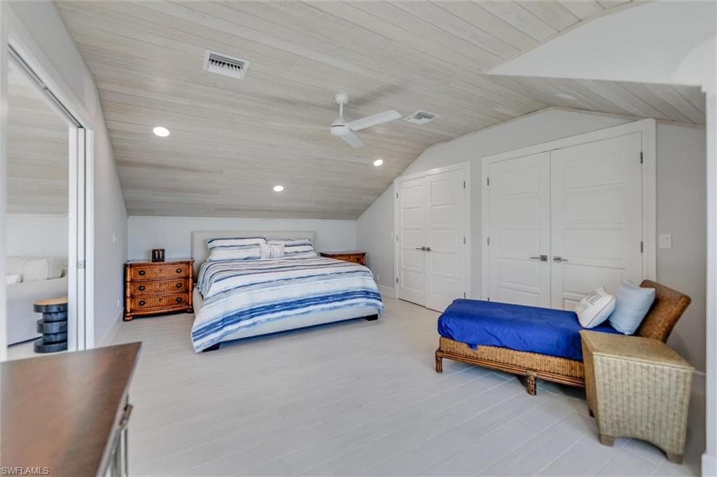 Bedroom with multiple closets, wood ceiling, recessed lighting, vaulted ceiling, and wood finished floors
