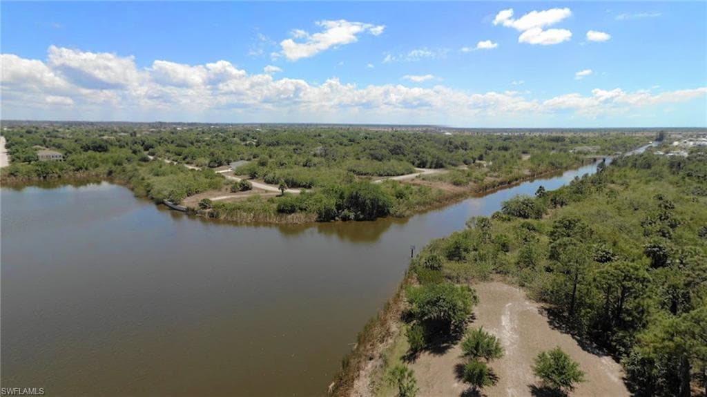 Aerial view of a heavily wooded area and a large body of water