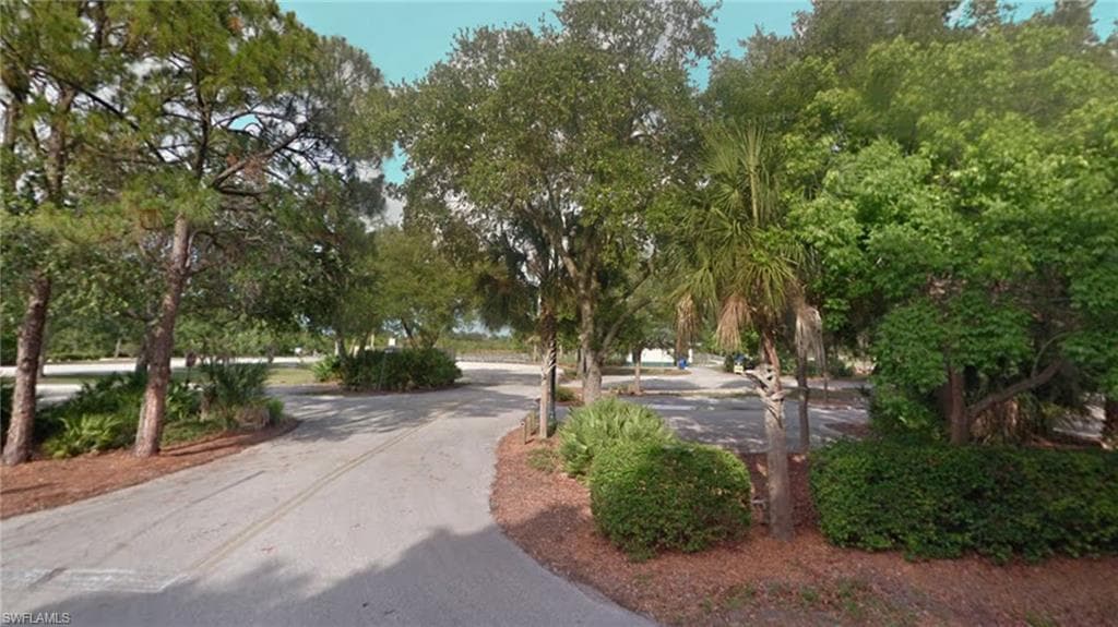 View of home's community with view of wooded area