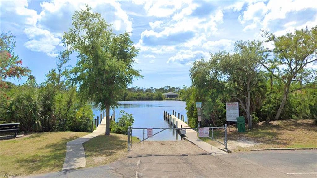Water view with a boat ramp and a dock