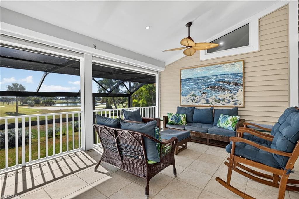 Sunroom featuring lofted ceiling, healthy amount of natural light, and a water view