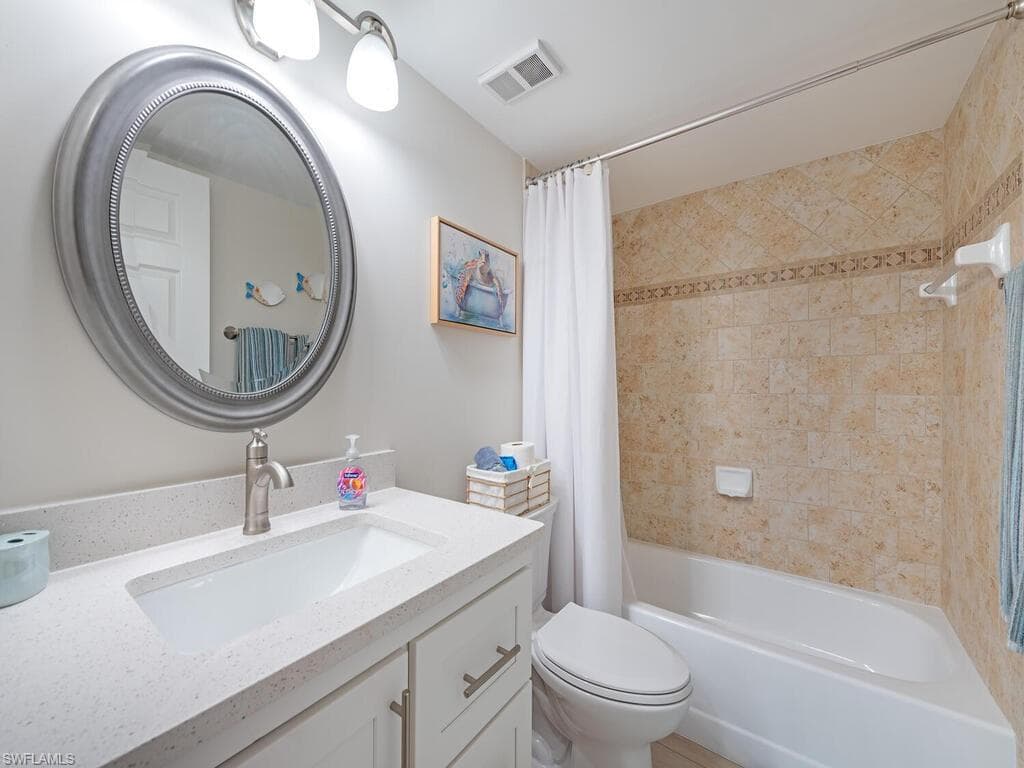 Bathroom featuring vanity and shower / tub combo