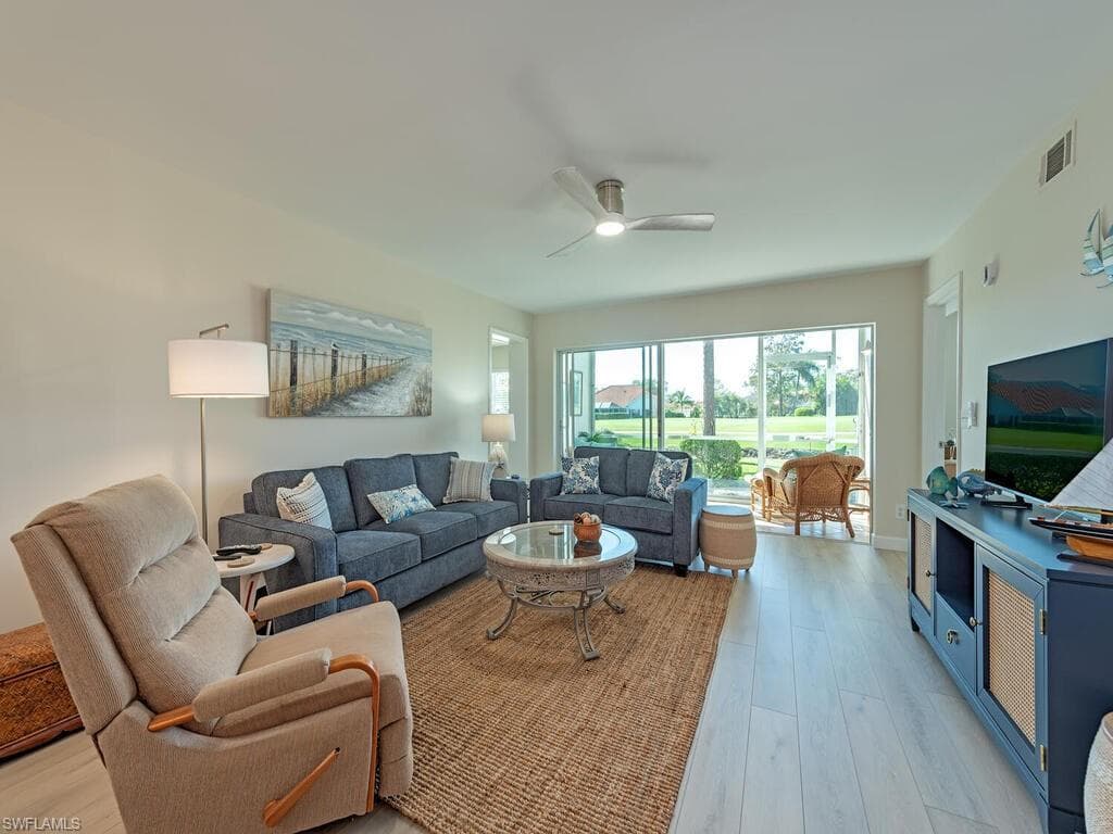 Living area featuring light wood-type flooring and a ceiling fan
