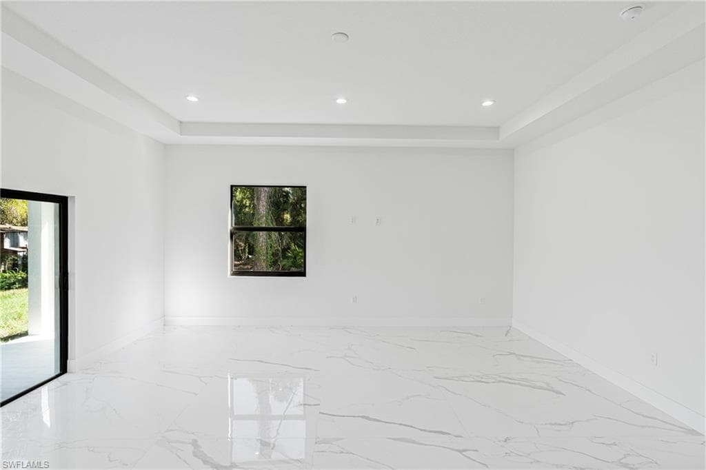 Spare room with marble tiled floors and recessed lighting