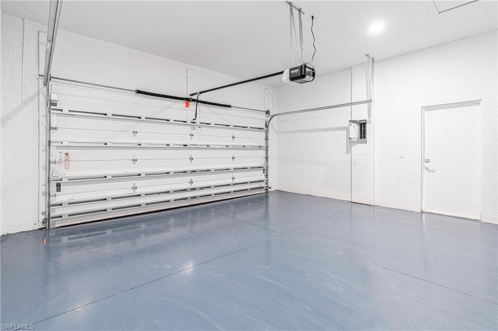 Garage with electric panel and a garage door opener