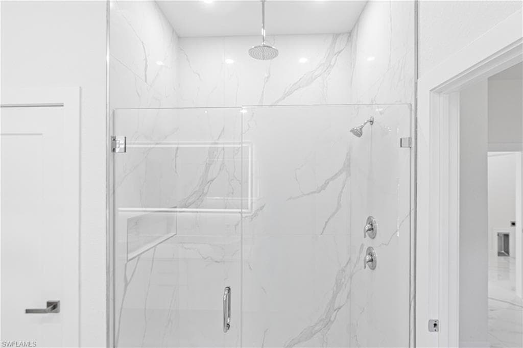 Full bathroom with a marble finish shower