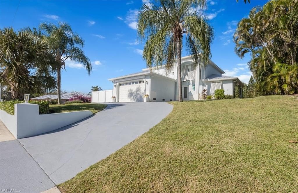 This lovely two-story home sits 17' above sea level and is fully shuttered on all openings
