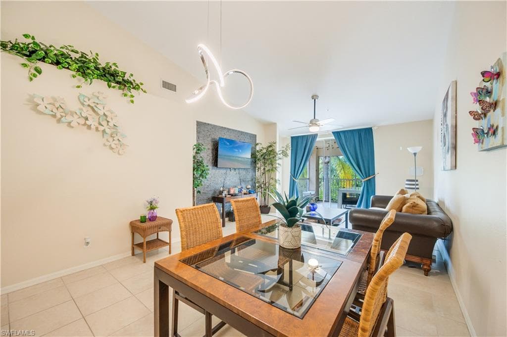 Dining room with a ceiling fan and light tile patterned floors