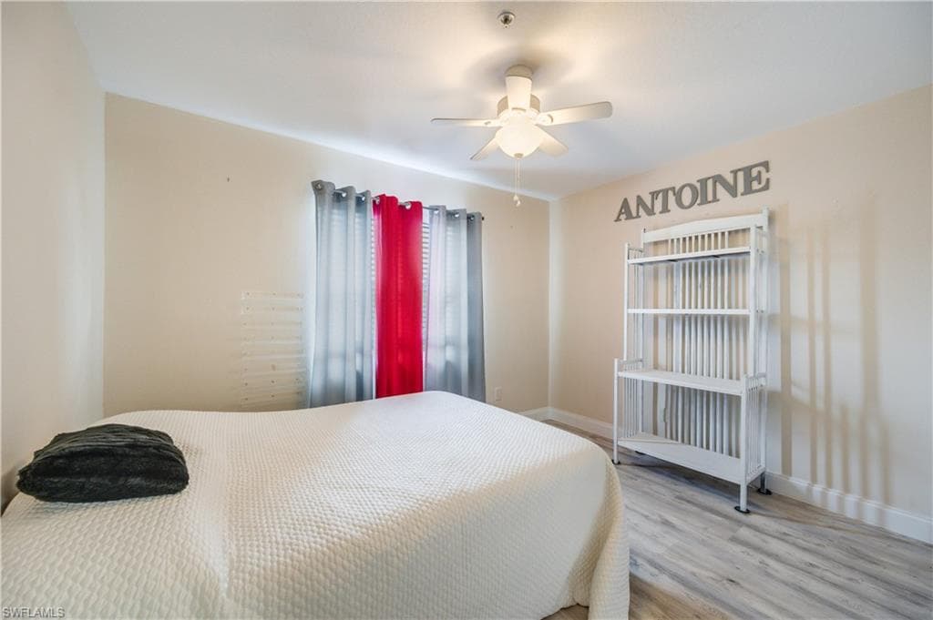 Bedroom featuring wood finished floors and a ceiling fan