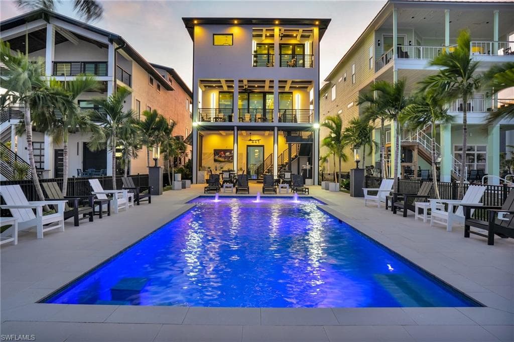 Rear view of property featuring stairway, a patio, and ceiling fan - Virtually Edited Image