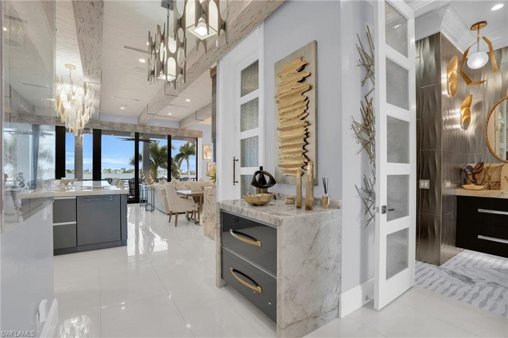 Bar area with modern cabinets, a chandelier, pendant lighting, and recessed lighting - Virtually Edited Image