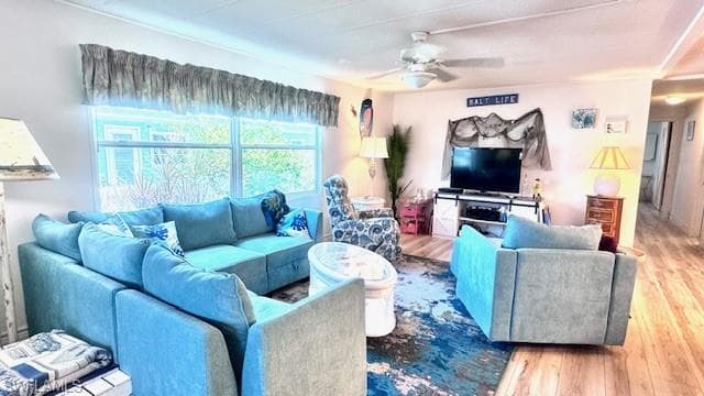 Living room with hardwood / wood-style flooring and ceiling fan