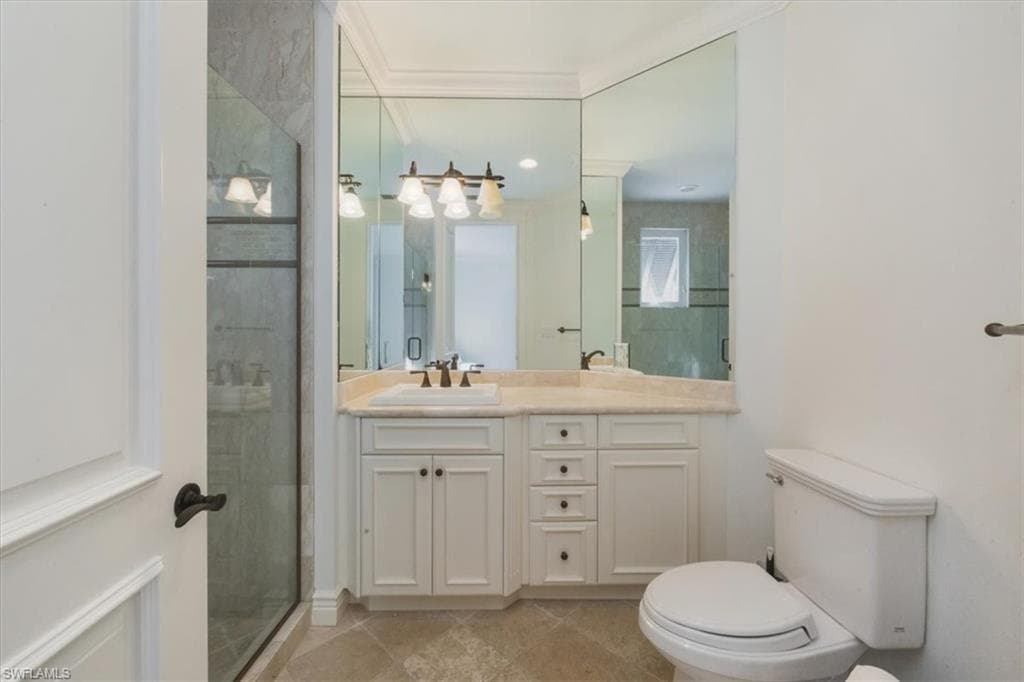 Full bath with vanity, a stall shower, and light tile patterned flooring