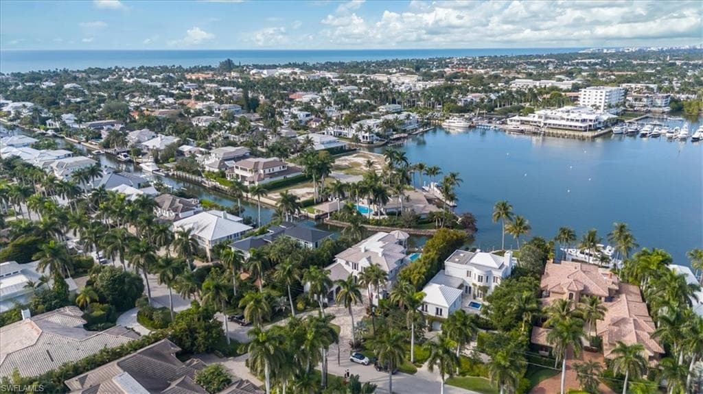 Aerial overview of property's location featuring a nearby body of water and nearby suburban area
