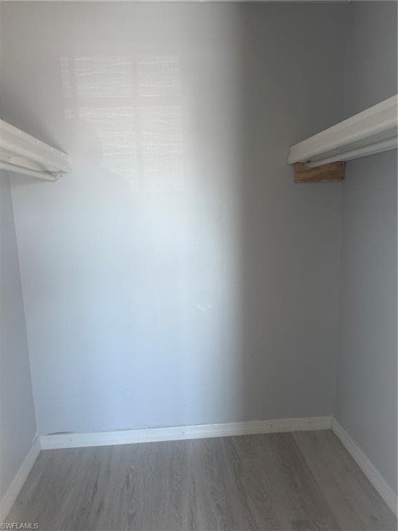 Walk in closet featuring light wood finished floors