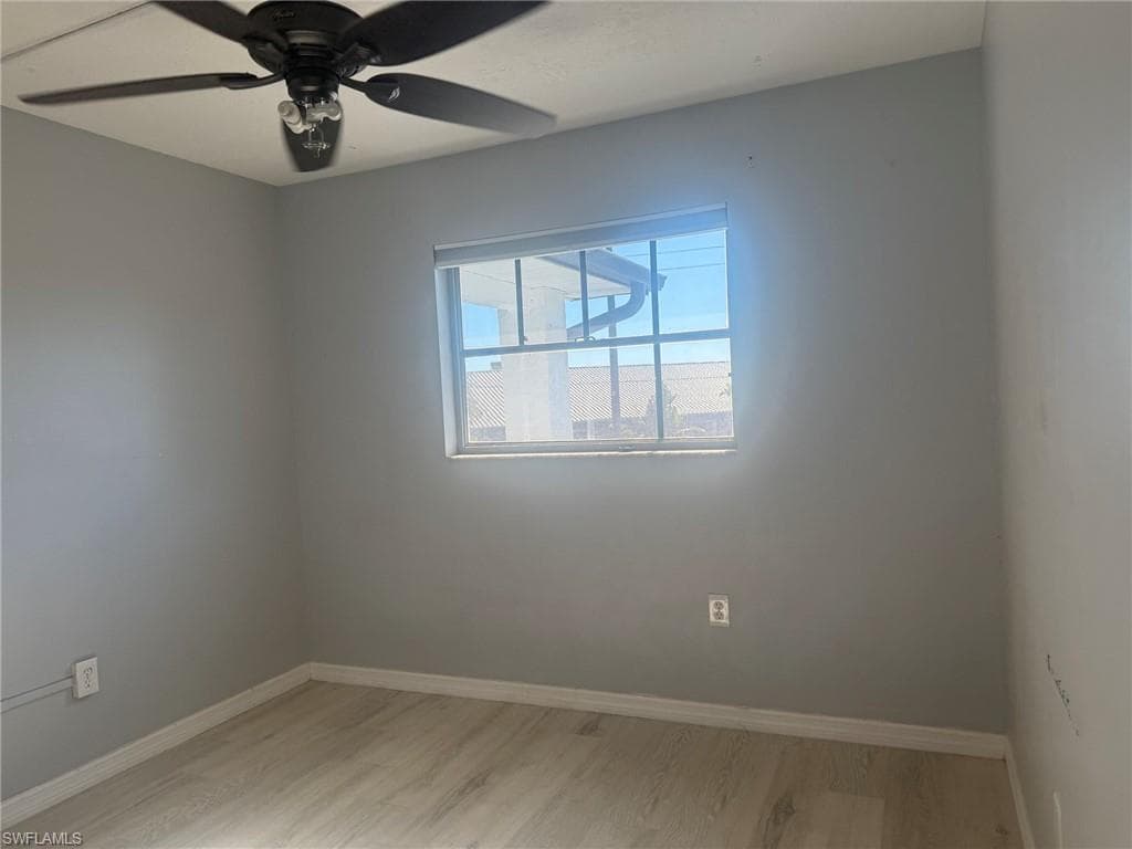 Empty room featuring ceiling fan and light wood-type flooring