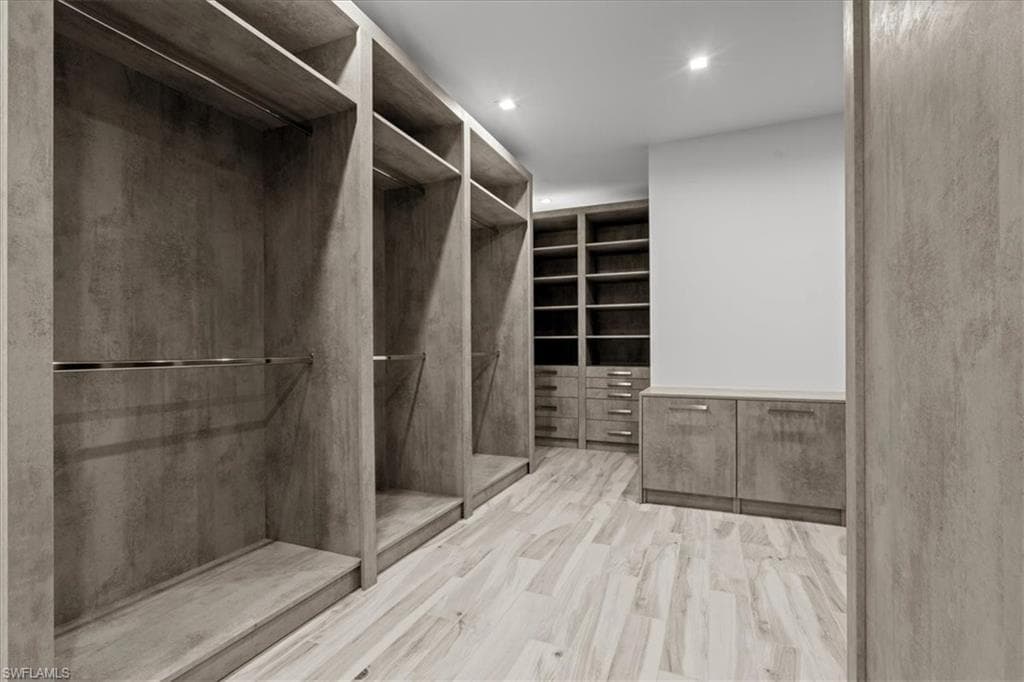 Walk in closet with wood finished floors