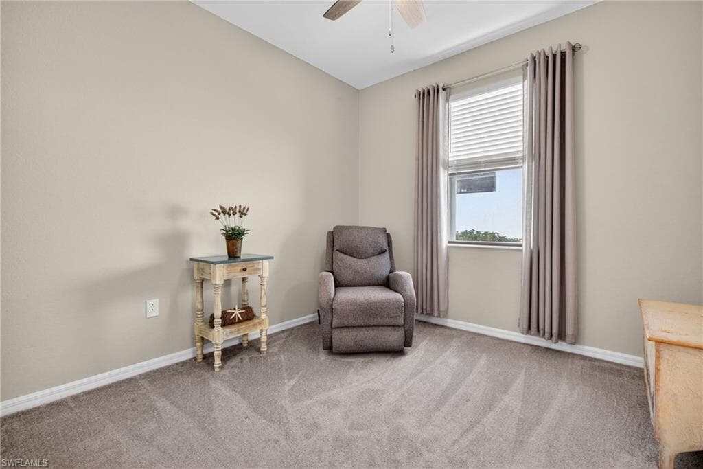 Sitting room with carpet floors and a ceiling fan