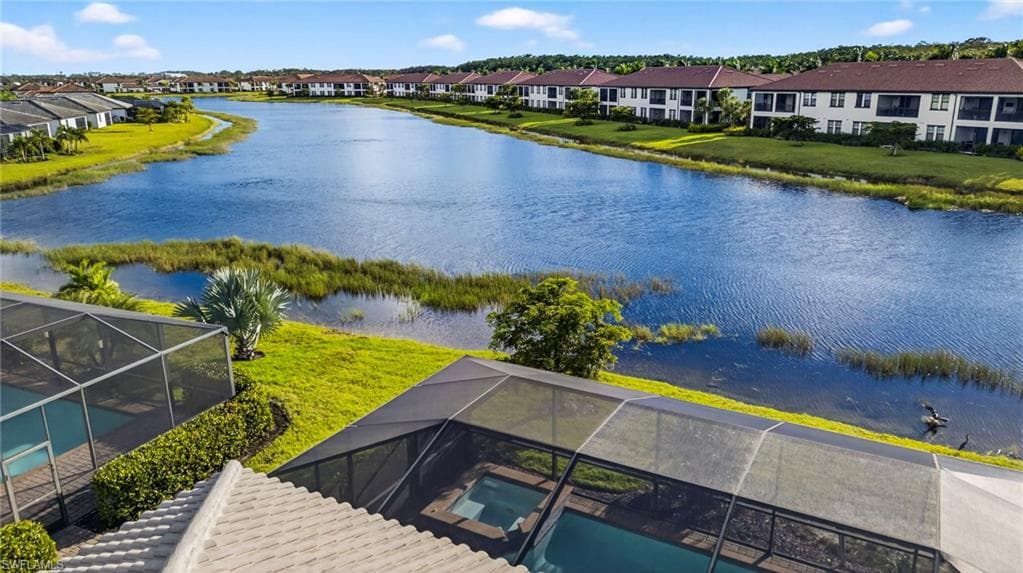 Aerial view of residential area featuring a nearby body of water