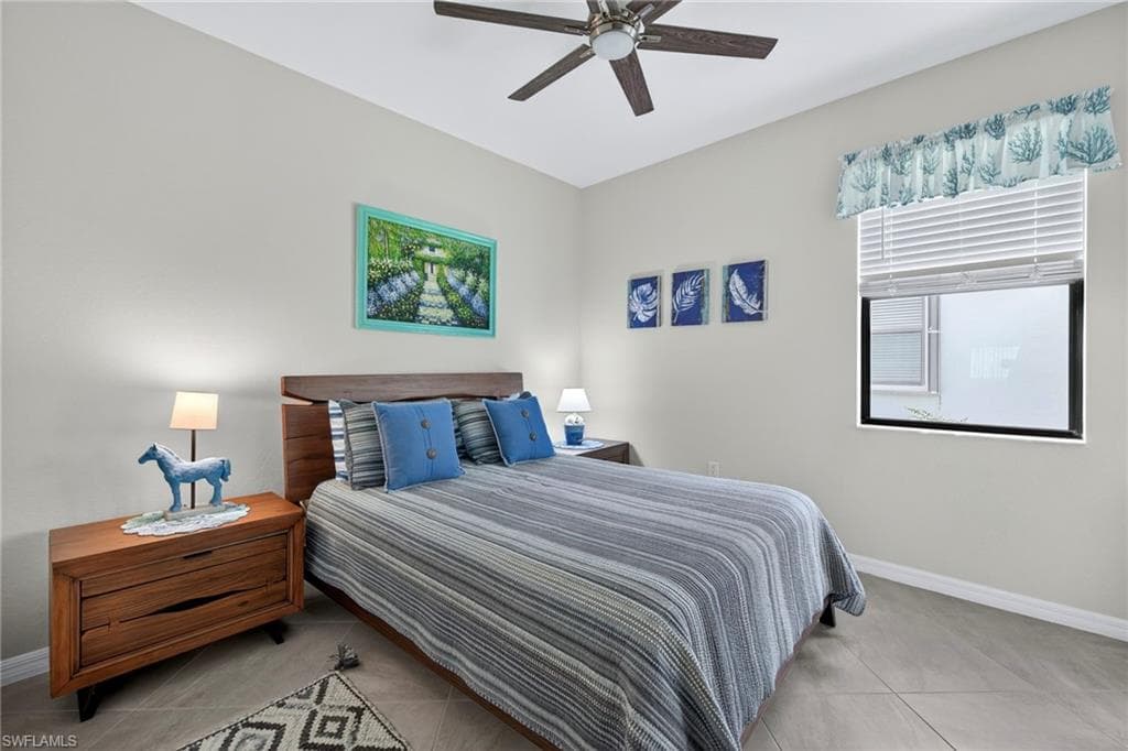 Bedroom featuring light tile patterned flooring and ceiling fan