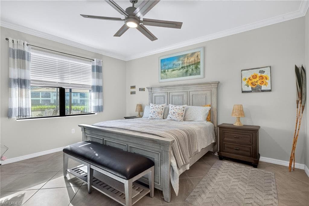 Bedroom featuring crown molding, a ceiling fan, and light tile patterned floors