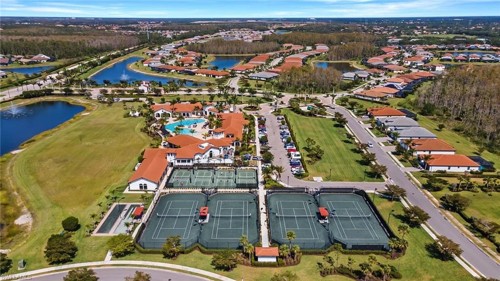 Aerial view of property's location featuring a nearby body of water and a golf club