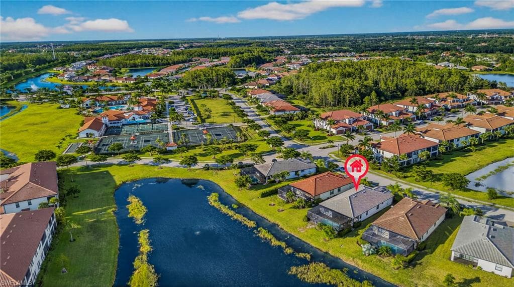 Aerial perspective of suburban area featuring a large body of water