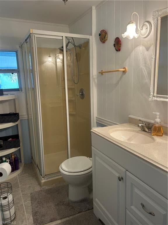 Full bathroom with vanity, a shower stall, and light tile patterned floors