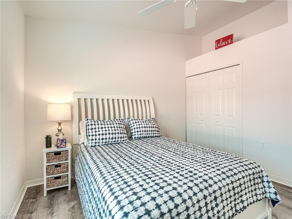 Bedroom featuring a closet, wood finished floors, and ceiling fan