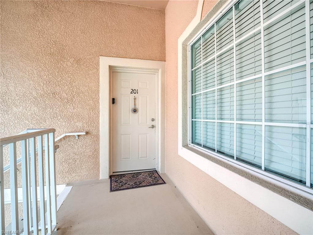 Property entrance featuring stucco siding
