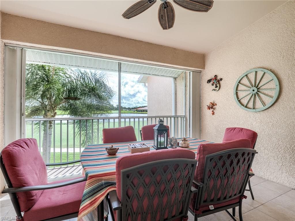 Sunroom / solarium featuring a water view