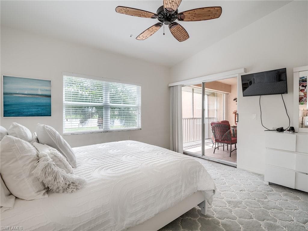 Bedroom featuring access to outside, ceiling fan, and lofted ceiling
