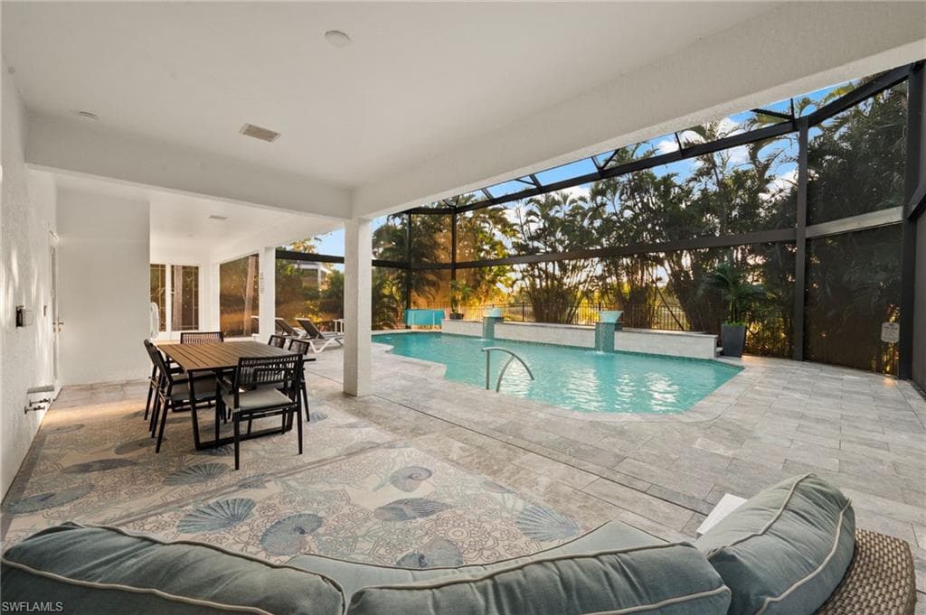 Outdoor pool featuring a patio area, and a under truss lanai plumbed and ready for your outdoor kitchen touch.