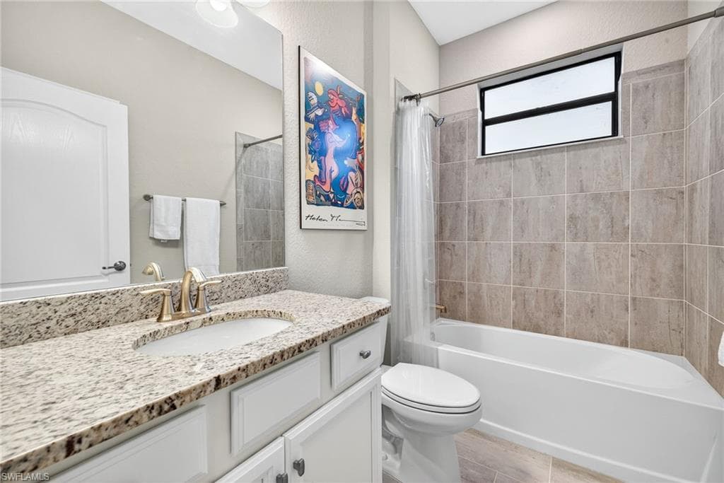 Full bath featuring shower / tub combo with curtain and vanity