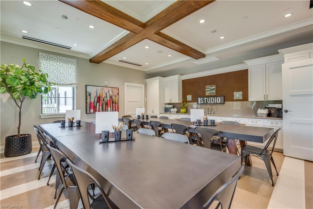 Dining space with beamed ceiling, ornamental molding, and recessed lighting