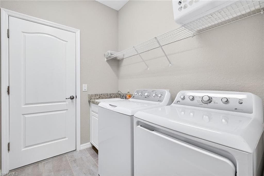 Laundry room with independent washer and dryer and cabinet space