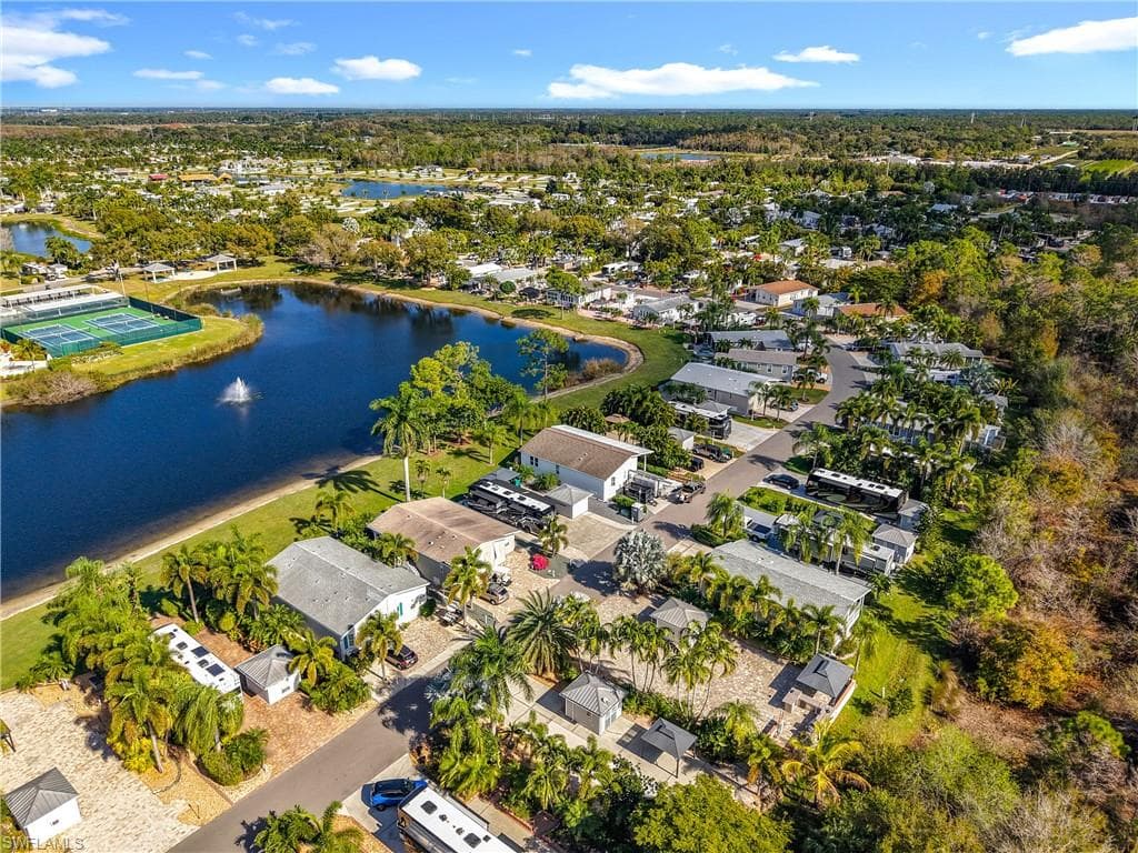 Aerial view of residential area featuring a nearby body of water