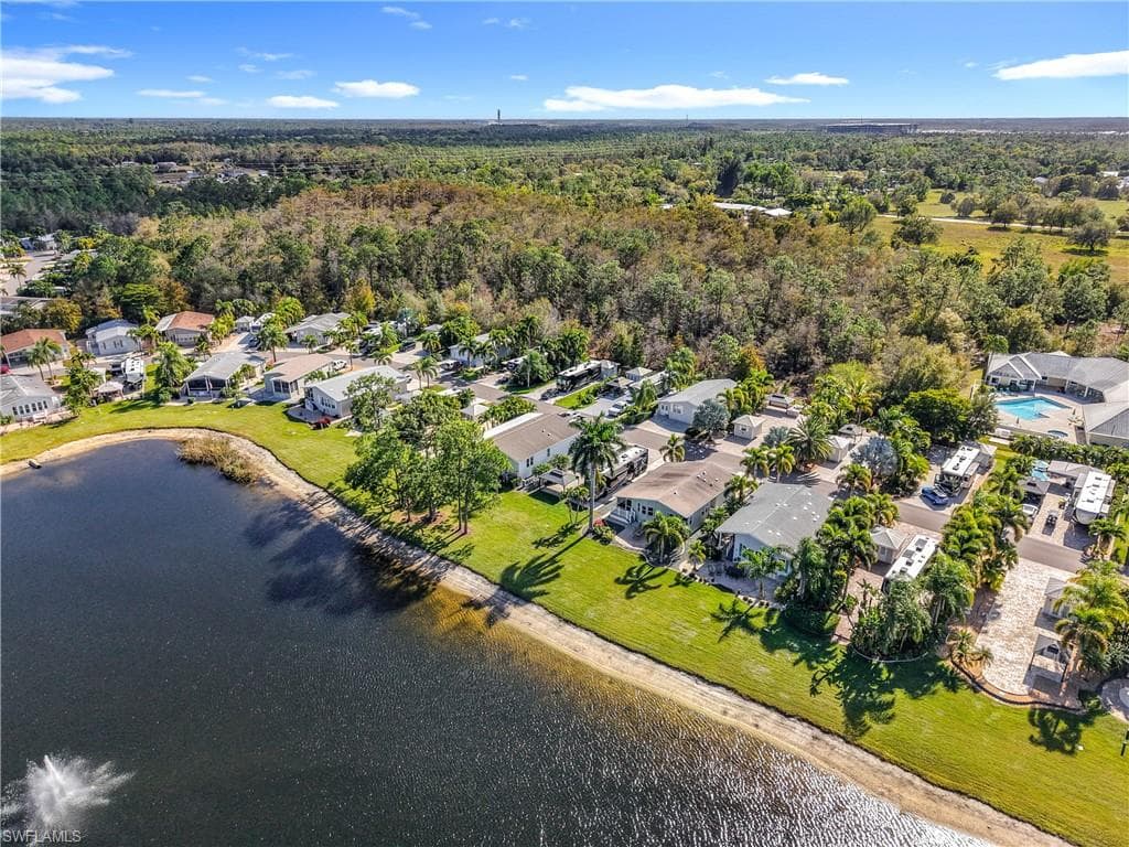 Aerial perspective of suburban area featuring a nearby body of water