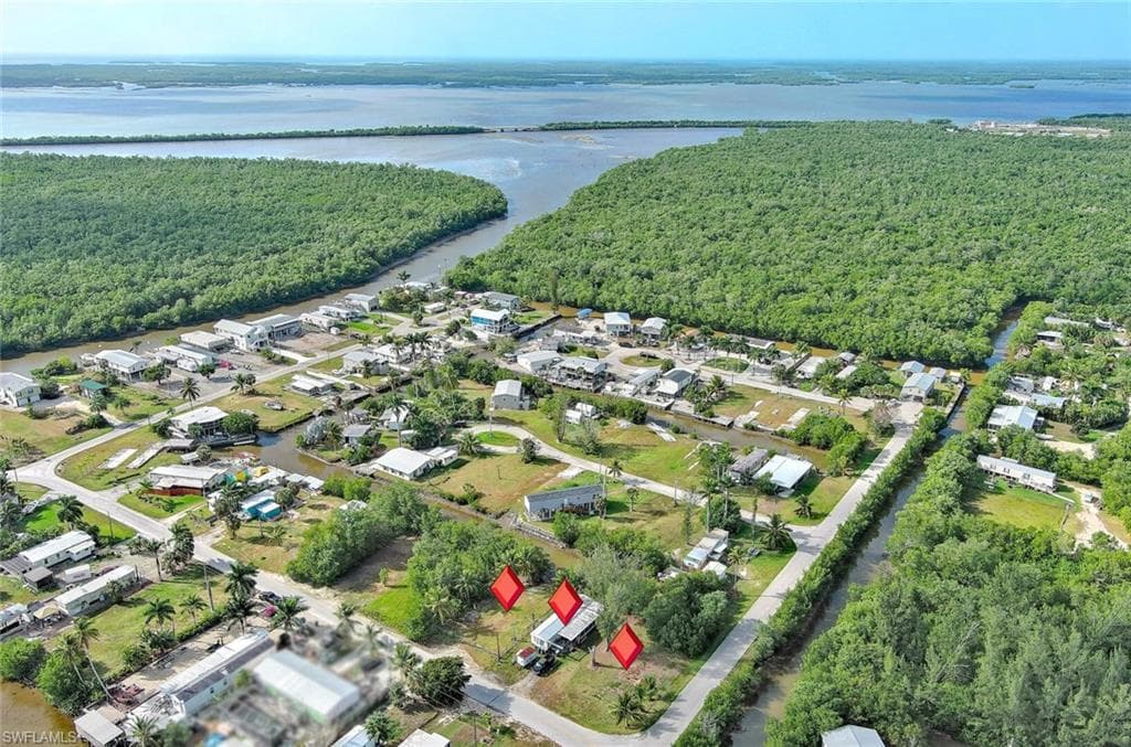 Aerial view of all 3 lots of property and surrounding area featuring a nearby body of water