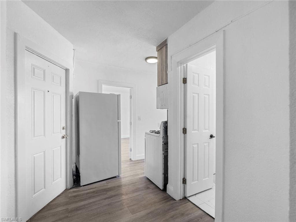 Corridor featuring dark wood-style floors