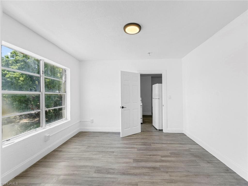 Empty room with light wood-style floors and baseboards