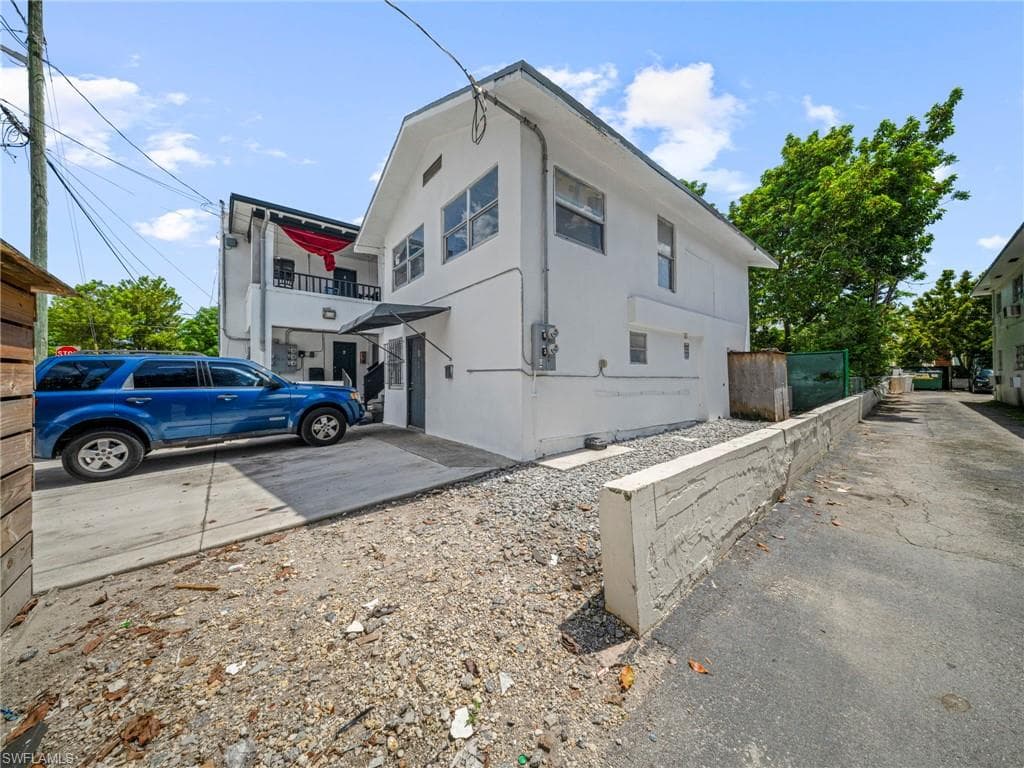 View of side of property with a balcony
