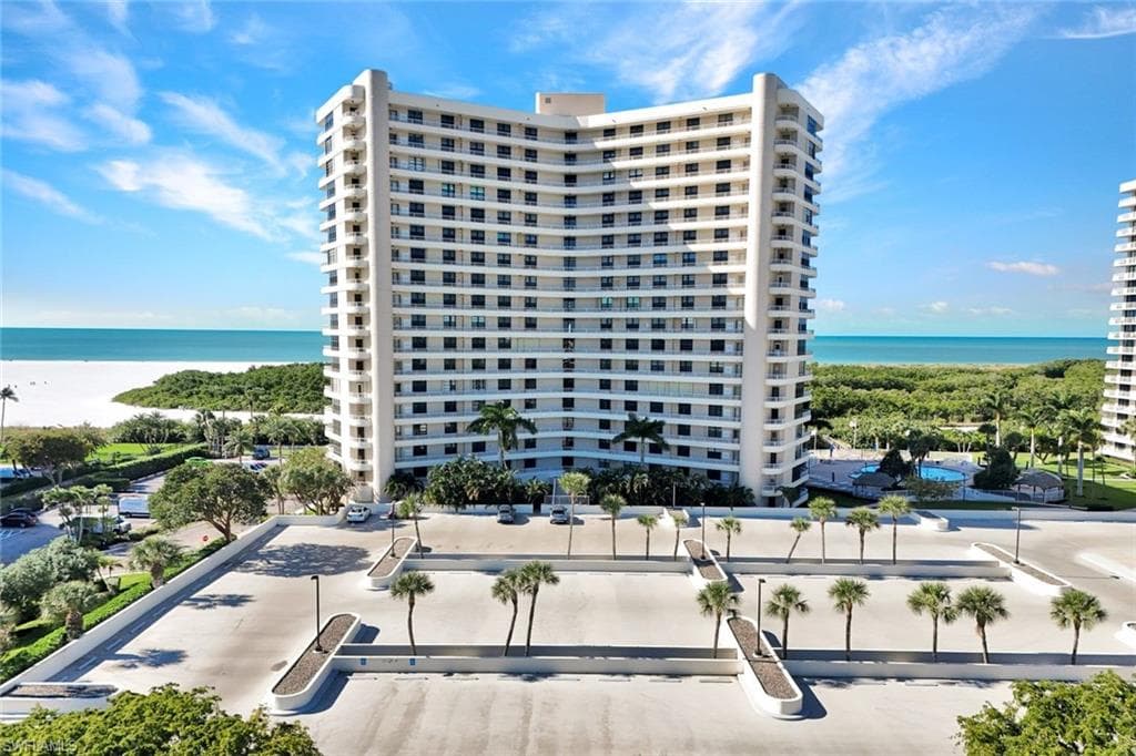 View of apartment building / complex featuring a water view
