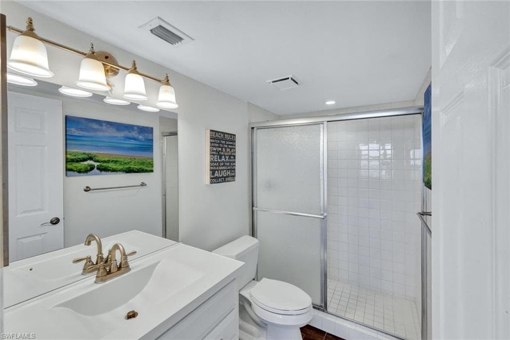 Bathroom featuring vanity and a shower stall